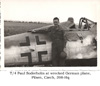 T/4 Paul Soderholm and wrecked German plane, Pilsen, Czech. 1945, 398-Hq
