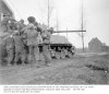 26 Feb 45 - Medics hoist wounded infantryman to tank