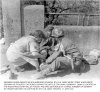11 Apr 45 - German nurse helps medic treating SS soldier
