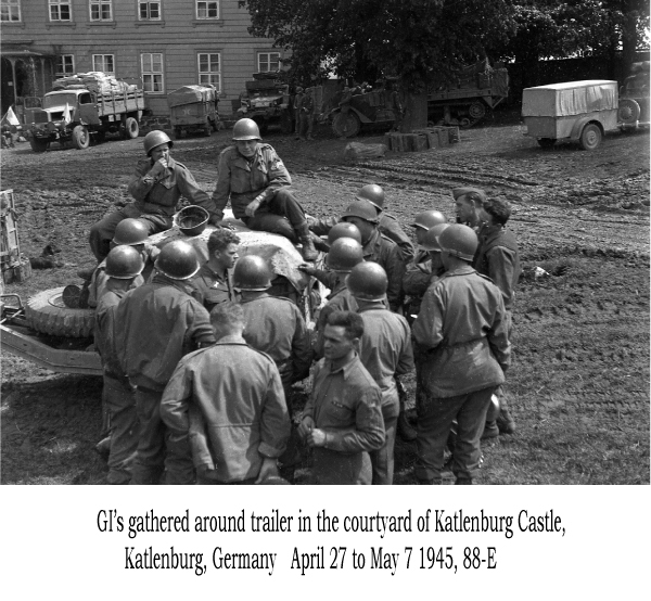 GI's gathered around a trailer in the courtyard of Katlenburg Castle, 88-E