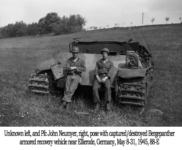 Unknown left, and Pfc John Neumyer; right, pose with captured/destroyed Bergepanther armored recovery vehicle, Ellierode, Germany, May 8-31 1945, 88-E