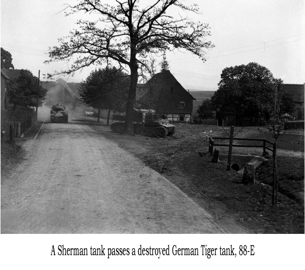 A Sherman tanks passes a destroyed German Tiger tank, 88-E