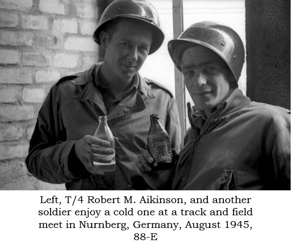 Two unidentified soldiers enjoy a cold one at track and field meet in Nurnberg, Germany, Aug 1945, 88-E