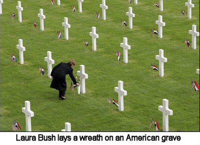 Laura Bush lays a wreath on an American grave