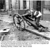 13 Mar 45 - German lad tinkers with knocked out Nazi gun